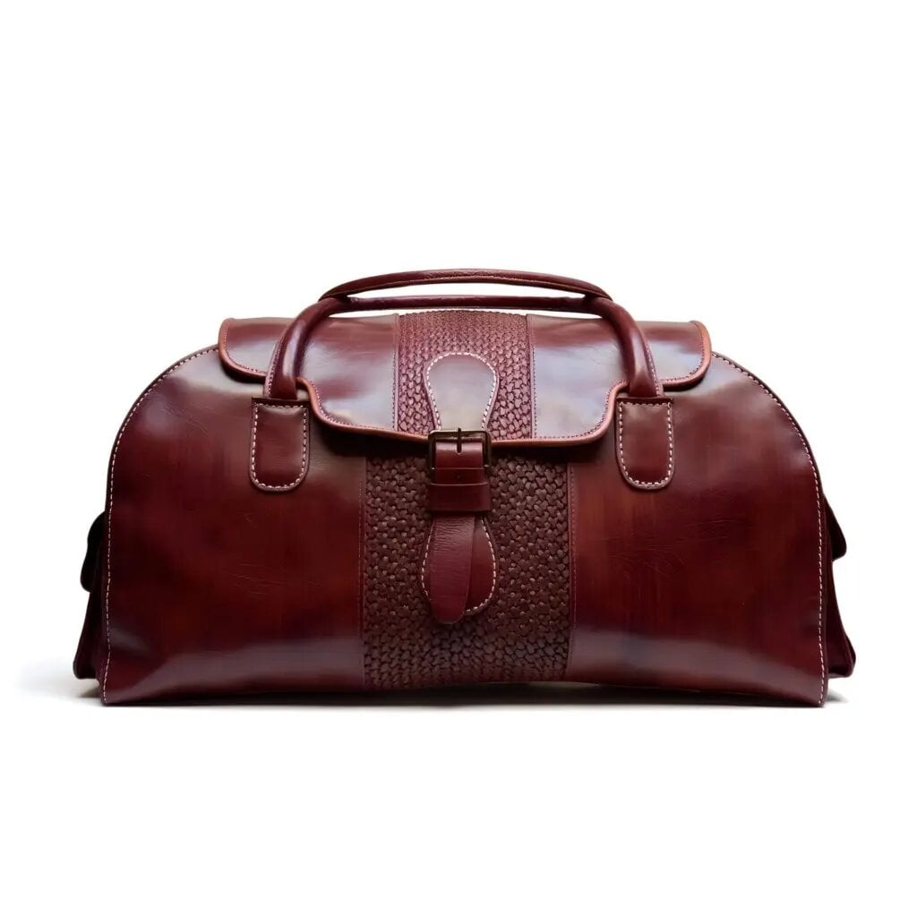 Brown leather weekender bag for men with embossed basketweave panel, brass hardware, and saddle stitching on white studio background