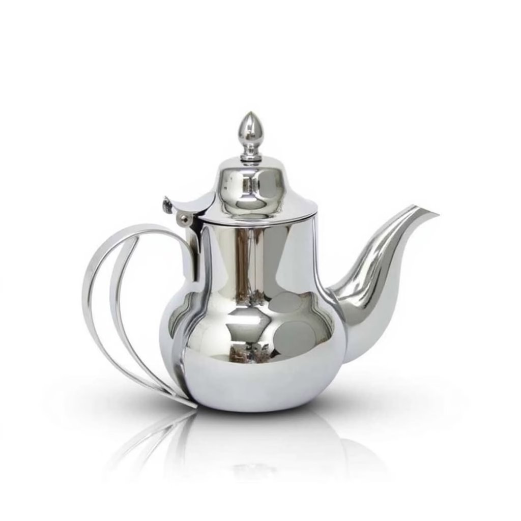 Stainless steel Moroccan teapot with mirror-polished finish, curved spout, domed lid, and double-wire D-handle on a whit Stainless steel Moroccan teapot with mirror-polished finish, curved spout, domed lid, and double-wire D-handle on a white background.