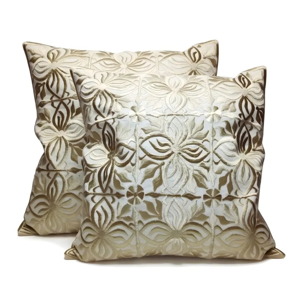 Beige leather pillow covers set with floral cutwork design stacked showing intricate dimensional appliqué detail Beige leather pillow covers set with floral cutwork design stacked showing intricate dimensional appliqué detail