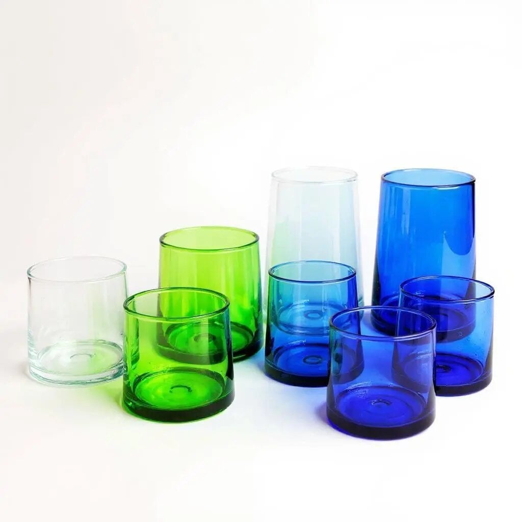 Group of eight handblown Moroccan wine glasses in mixed clear, green, aqua, and cobalt on white background Group of eight handblown Moroccan wine glasses in mixed clear, green, aqua, and cobalt on white background