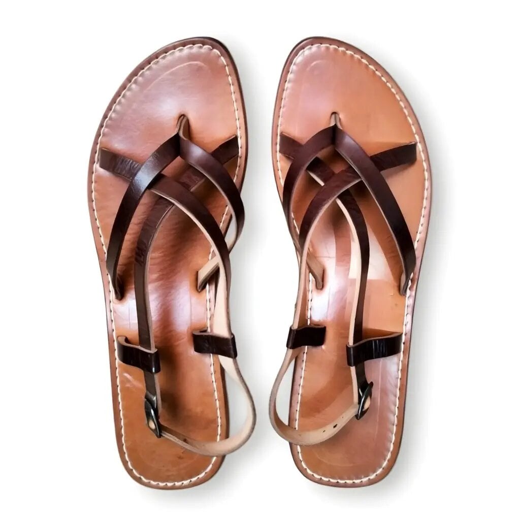 Handmade Moroccan leather sandals with dark brown cross-straps, tan sole, and white contrast stitching