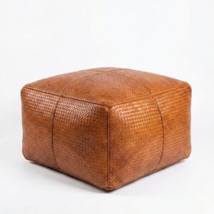 Braided leather square ottoman in cognac with herringbone weave pattern on white background Braided leather square ottoman in cognac with herringbone weave pattern on white background
