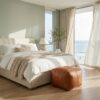 Braided leather square ottoman at the foot of a bed in coastal bedroom with ocean view