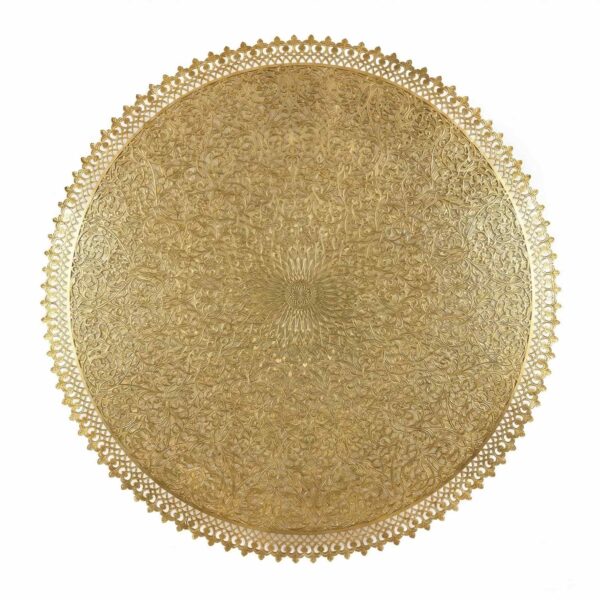 Close-up of hand-engraved brass filigree wall lamp showing arabesque floral patterns and scalloped decorative edge