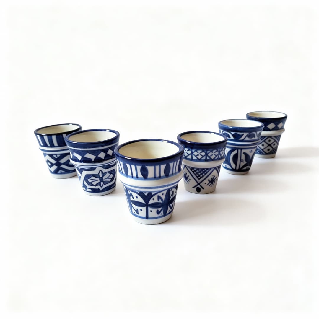 Complete set of six handpainted ceramic espresso cups showing variety of blue and white geometric patterns Complete set of six handpainted ceramic espresso cups showing variety of blue and white geometric patterns