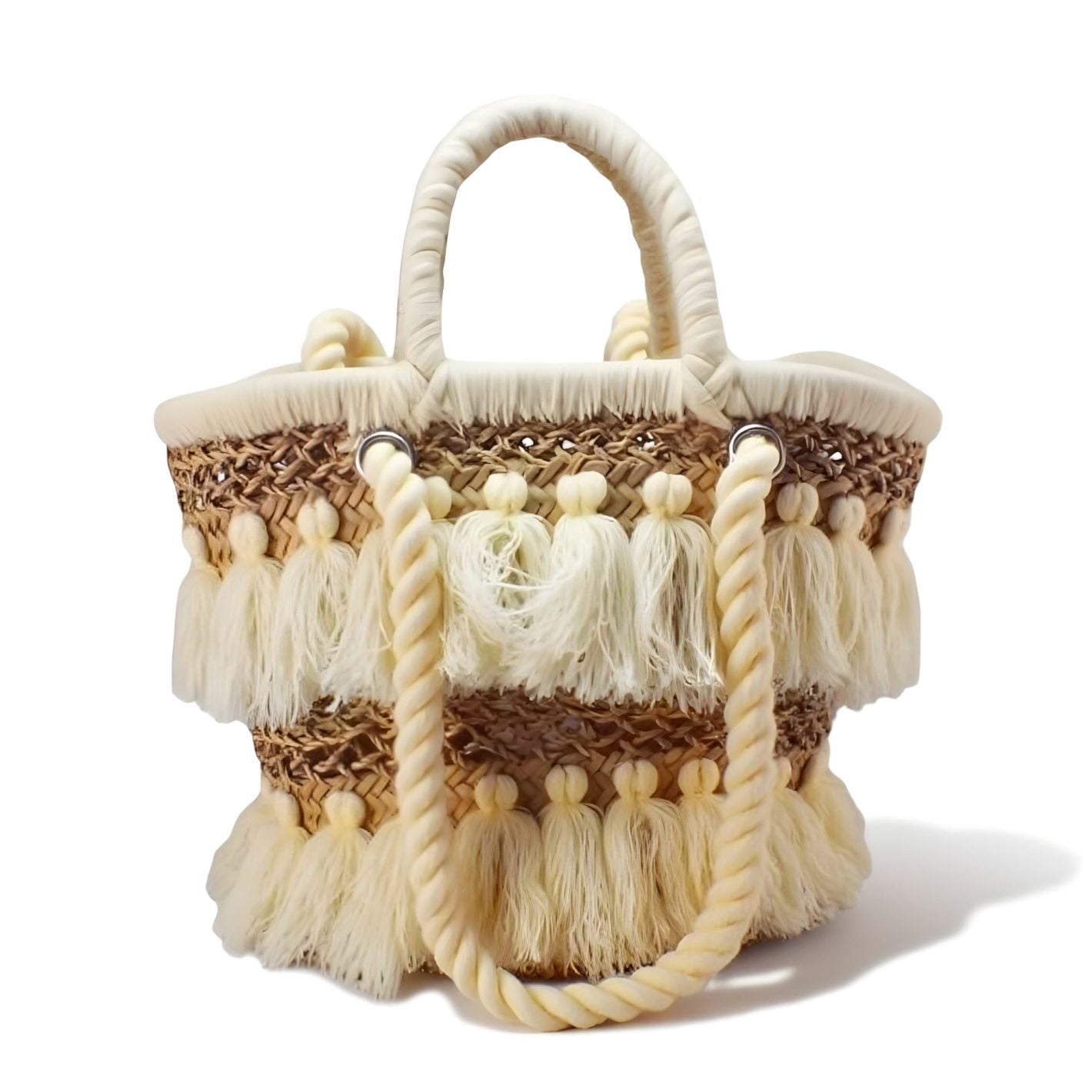 Handwoven beige tassel straw bag with cotton pom-pom fringe and wrapped rope handles on white background