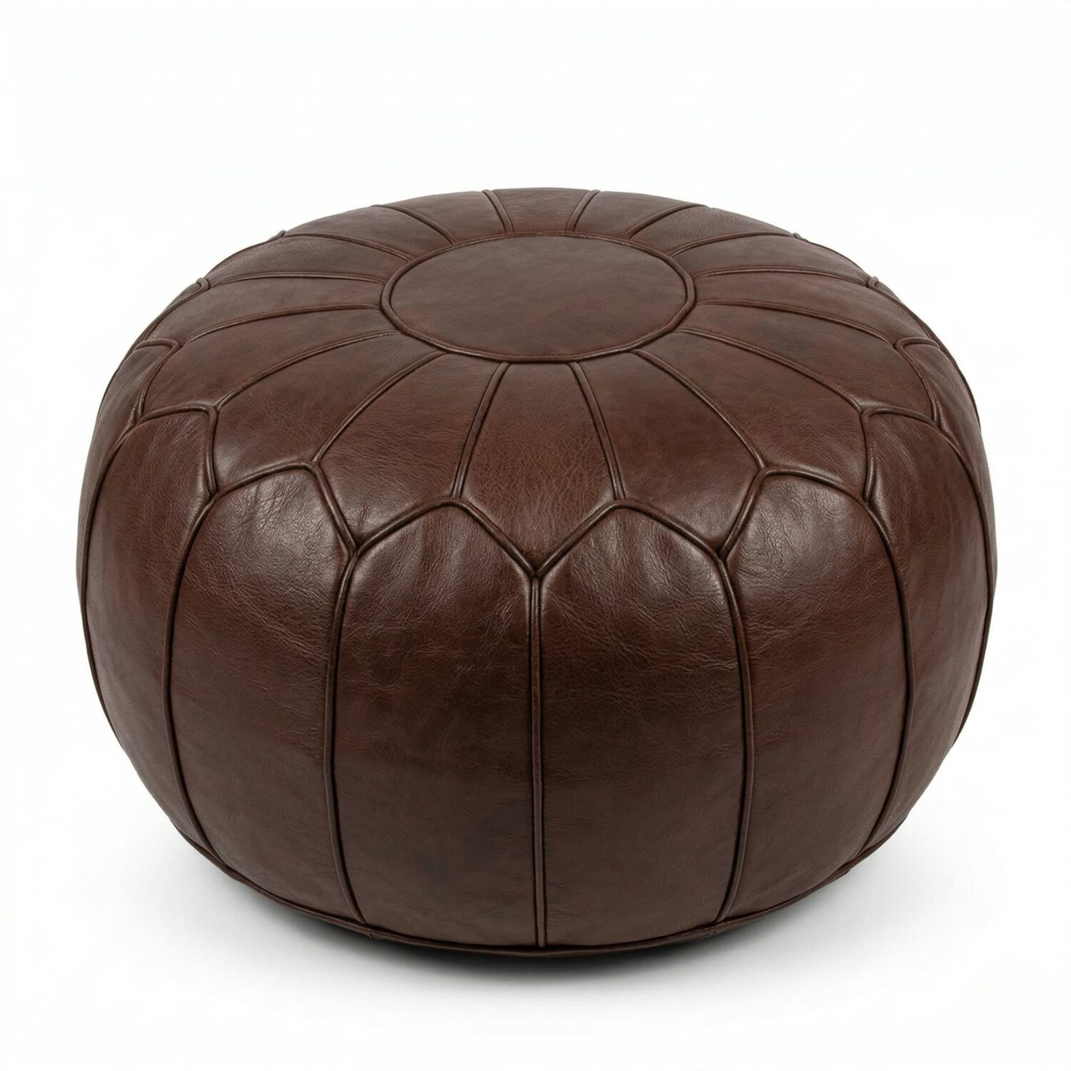 Chocolate brown leather round pouf with geometric patchwork stitching, handcrafted Moroccan ottoman on white background.