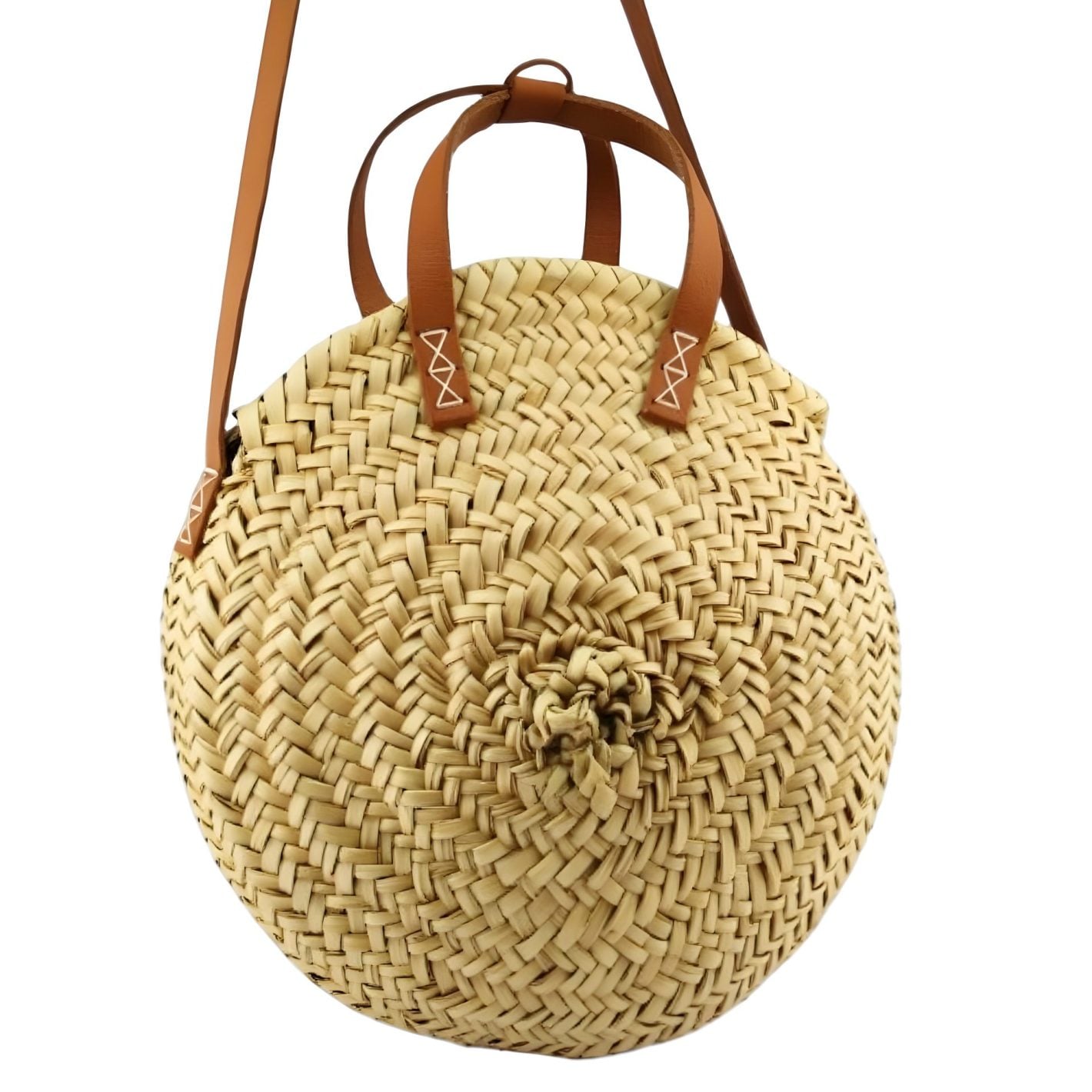 Round straw bag with herringbone weave pattern, woven rosette center, and cognac leather handles with white zigzag stitching