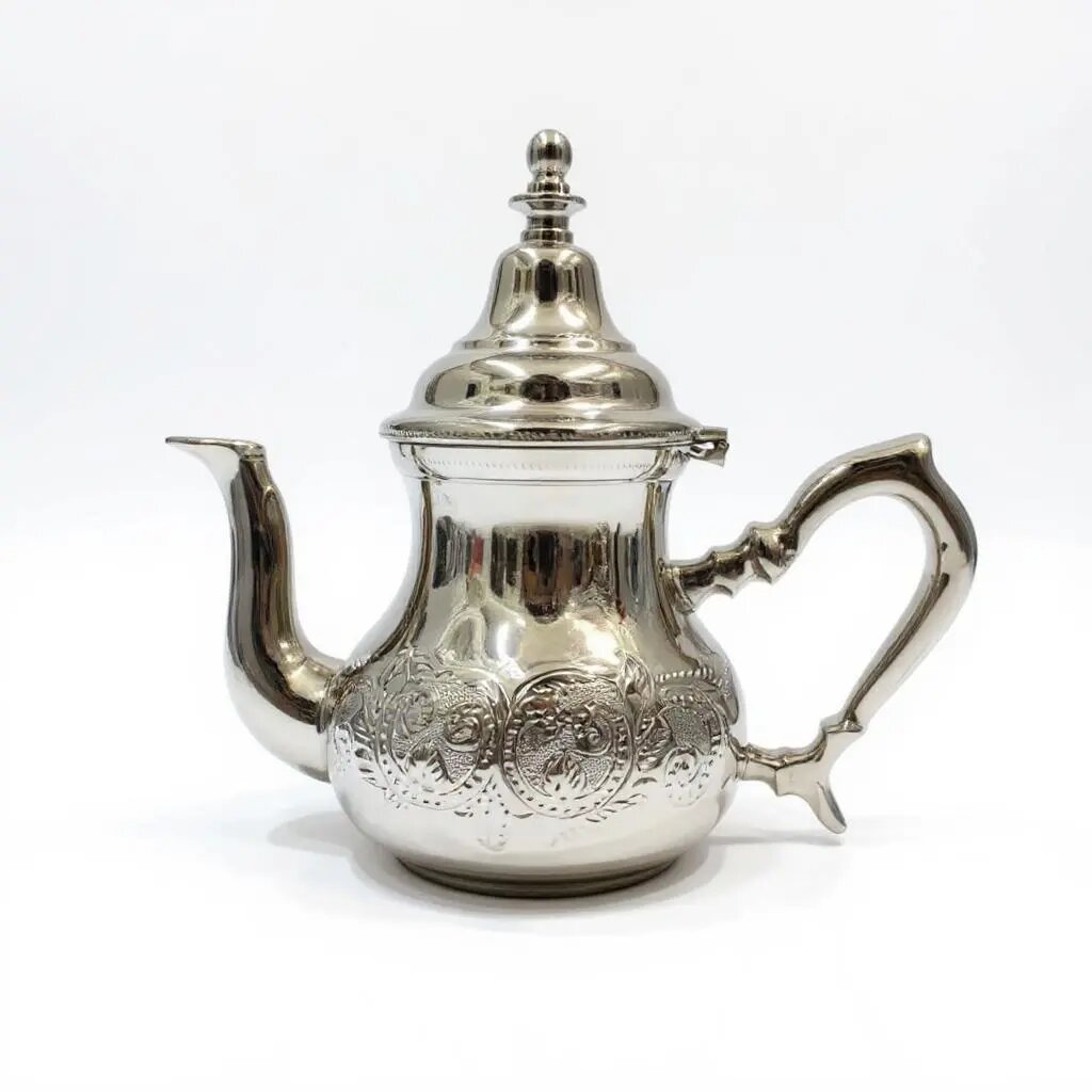 Classic atay silver teapot with hand-engraved arabesque motifs, wide shoulders, and two-tier bell dome lid on white Classic atay silver teapot with hand-engraved arabesque motifs, wide shoulders, and two-tier bell dome lid on white