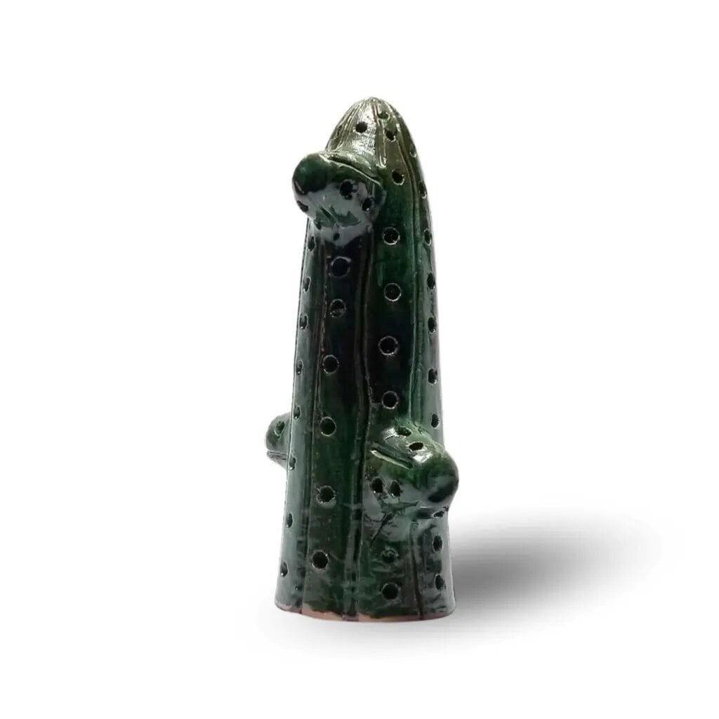 Green ceramic cactus handcrafted sculpture with glossy glaze and hand-stamped dots on white background Green ceramic cactus handcrafted sculpture with glossy glaze and hand-stamped dots on white background