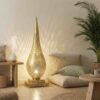 Brass floor lamp illuminating bohemian living space with floor cushions palm plant and natural textures casting geometric shadows on wall