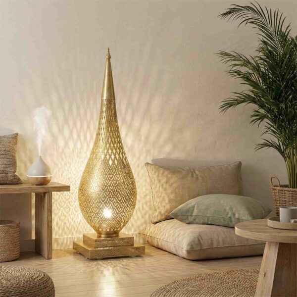 Brass floor lamp illuminating bohemian living space with floor cushions palm plant and natural textures casting geometric shadows on wall