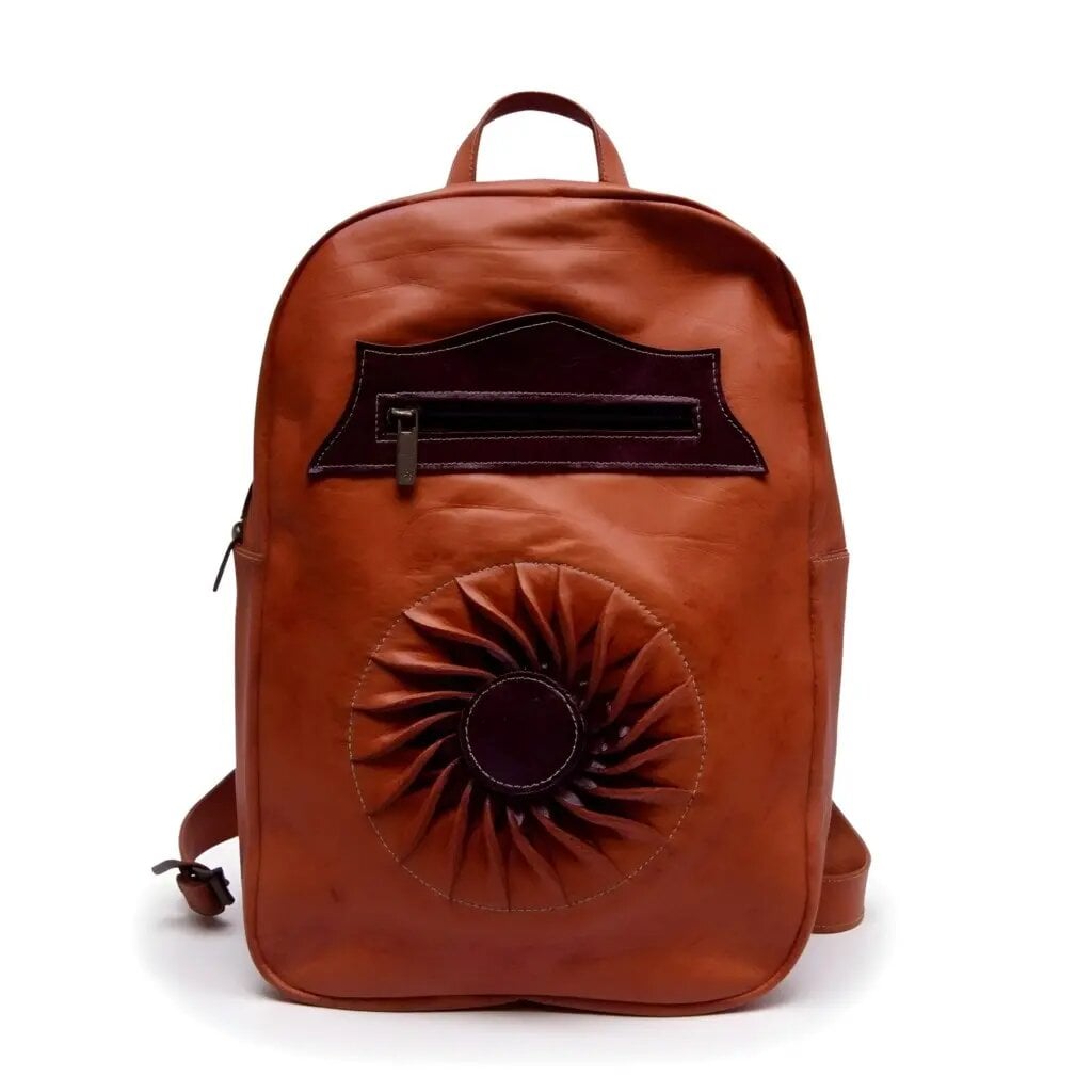 Cognac leather laptop backpack featuring hand-pleated sun rosette embossing, front zipper pocket, and brass hardware Cognac leather laptop backpack featuring hand-pleated sun rosette embossing, front zipper pocket, and brass hardware