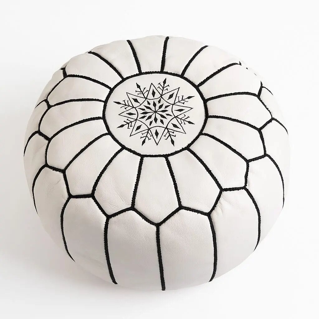 White leather geometric floor ottoman with central star medallion and radiating geometric embroidery White leather geometric floor ottoman with central star medallion and radiating geometric embroidery