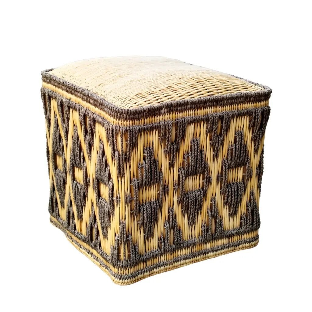 Handcrafted square straw floor pouf with diamond pattern on white background Handcrafted square straw floor pouf with diamond pattern on white background