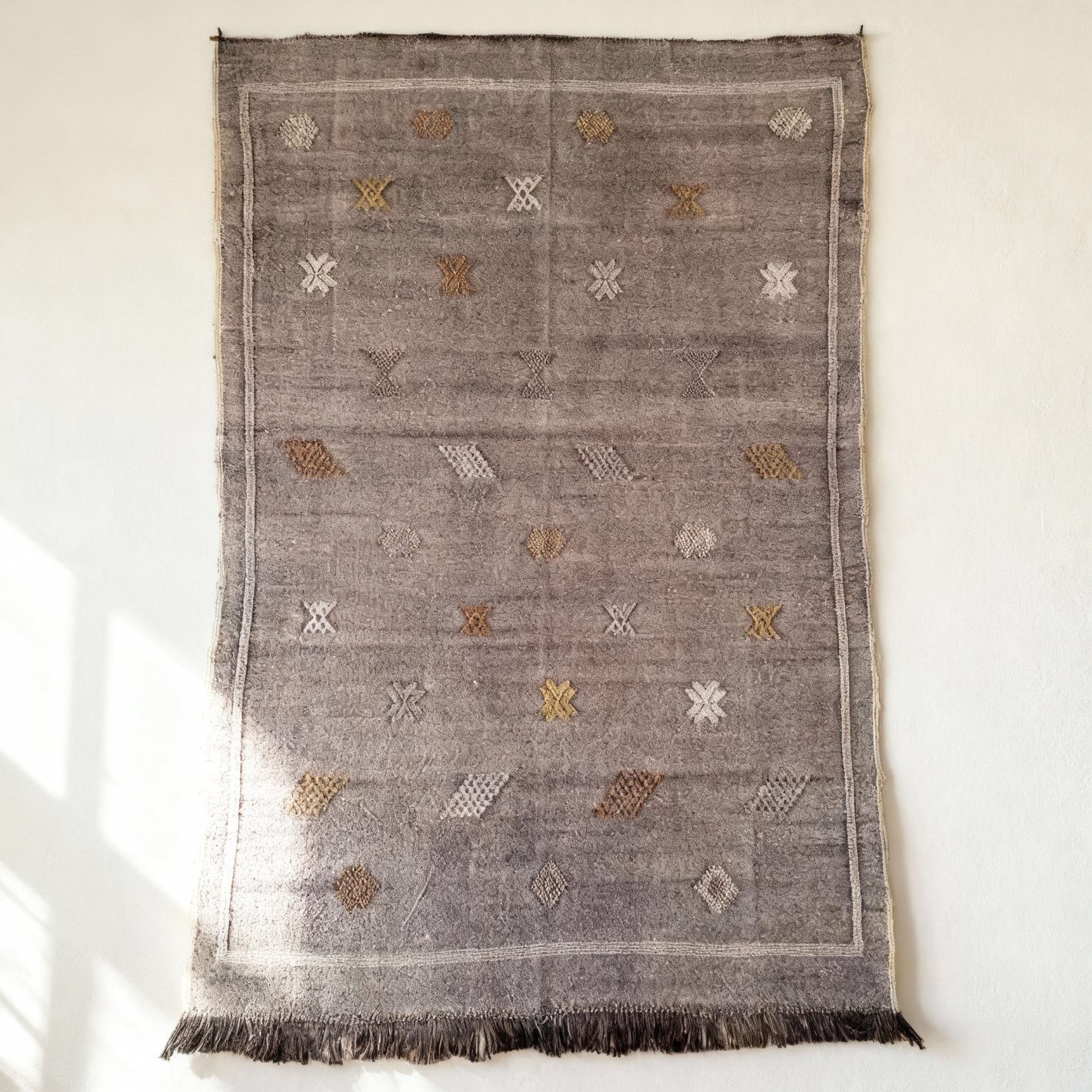 Purple cactus silk rug featuring handwoven geometric Berber patterns and fringed edges on a white background Purple cactus silk rug featuring handwoven geometric Berber patterns and fringed edges on a white background