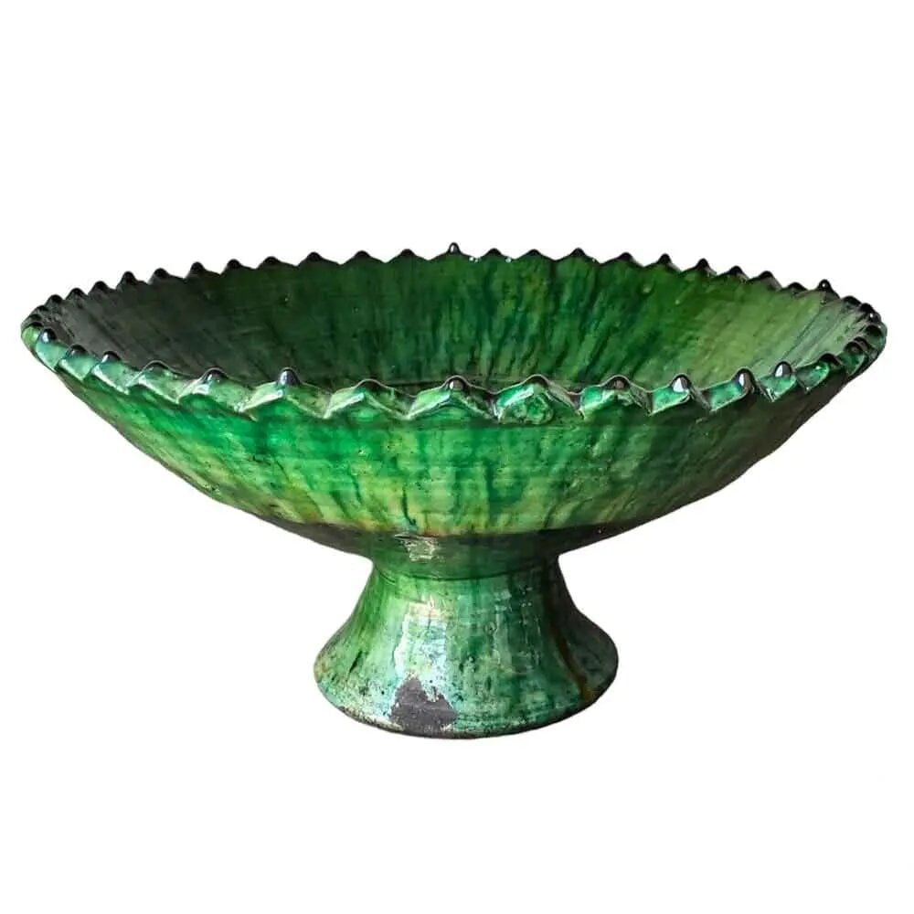 Handmade green ceramic pottery bowl with ruffled edge on pedestal base, traditional Moroccan design