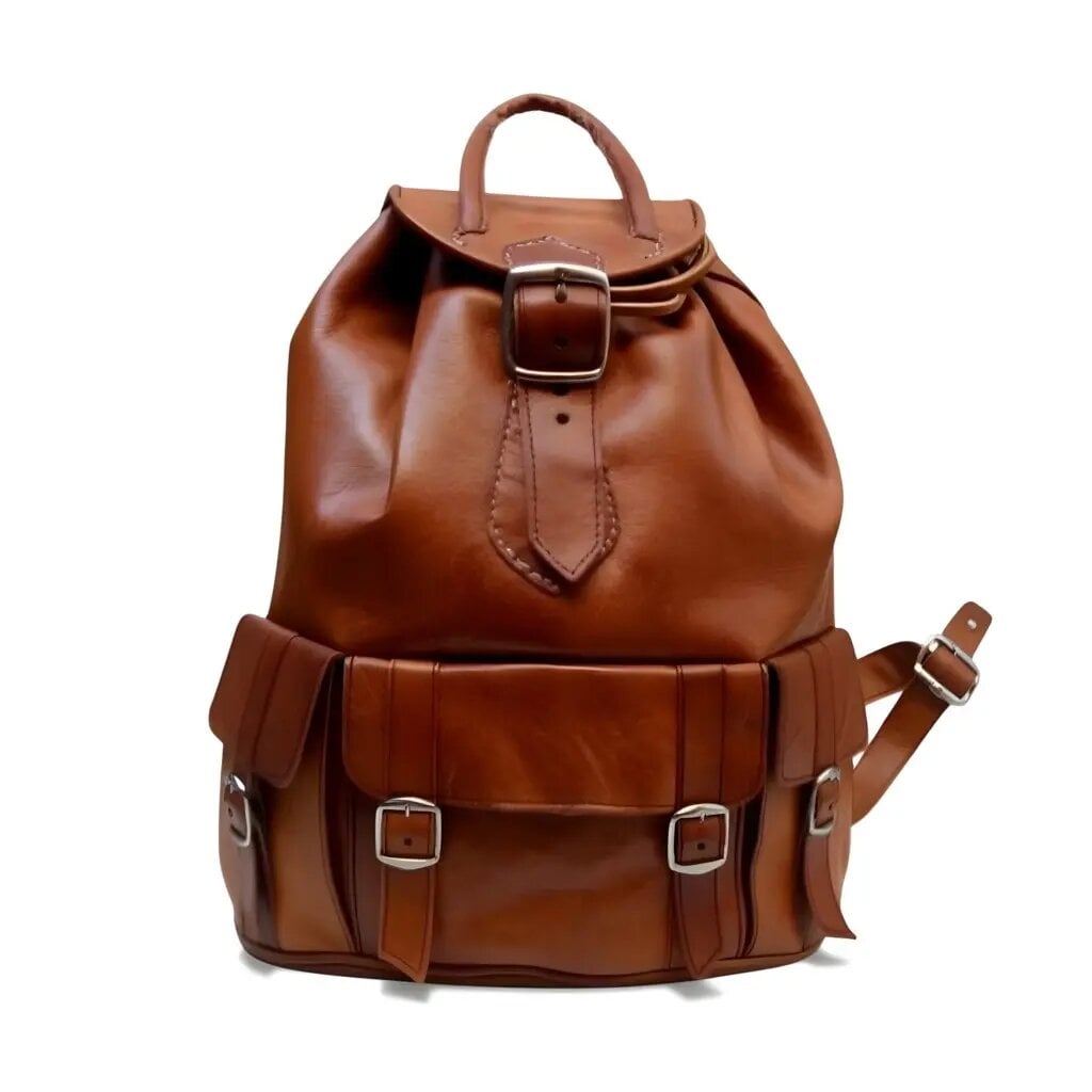 Brown leather buckle backpack with solid brass hardware and flap closure on white background