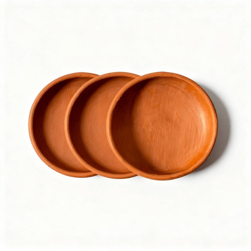 Handmade terracotta ceramic plates set of three with natural clay texture and warm rust-orange finish Handmade terracotta ceramic plates set of three with natural clay texture and warm rust-orange finish