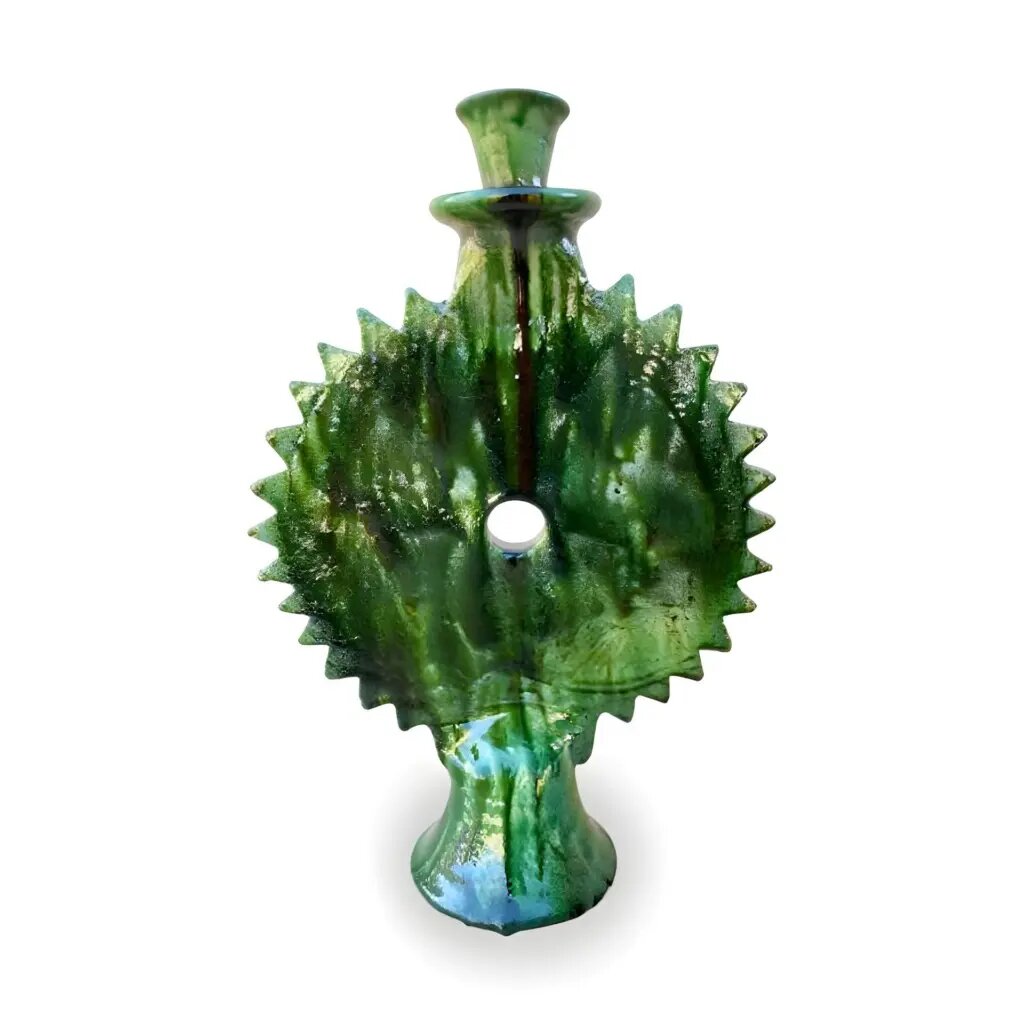 Handmade Tamegroute green ceramic candlestick with sunburst design and drip glaze, isolated on white background Handmade Tamegroute green ceramic candlestick with sunburst design and drip glaze, isolated on white background