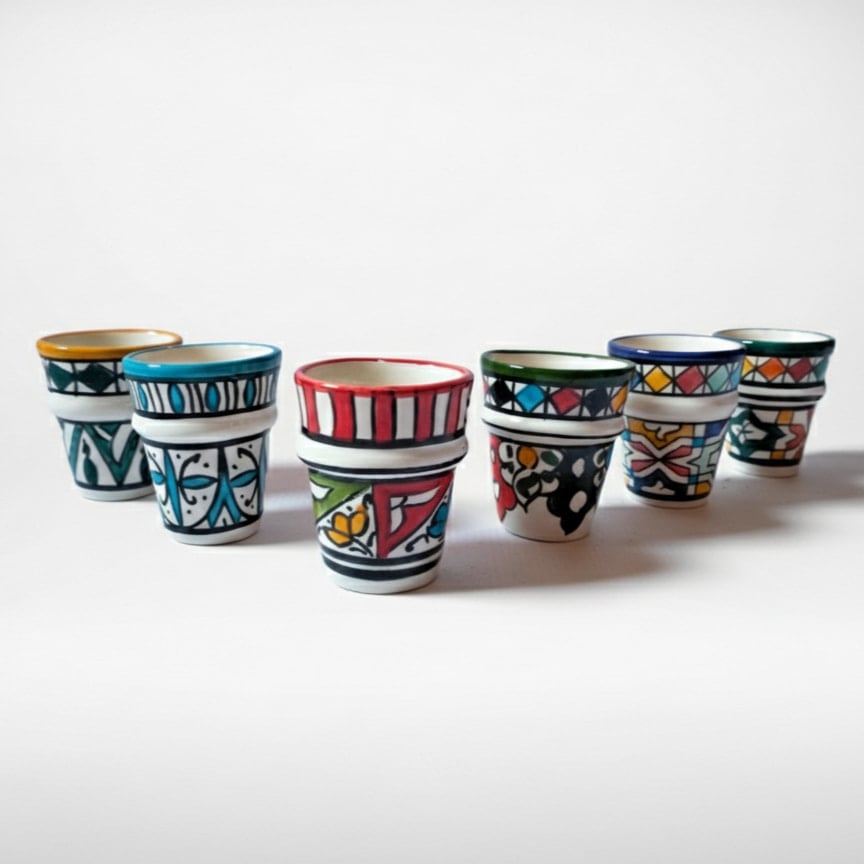 Handpainted ceramic espresso cups set with colorful geometric patterns in red, blue, green, and yellow designs Handpainted ceramic espresso cups set with colorful geometric patterns in red, blue, green, and yellow designs