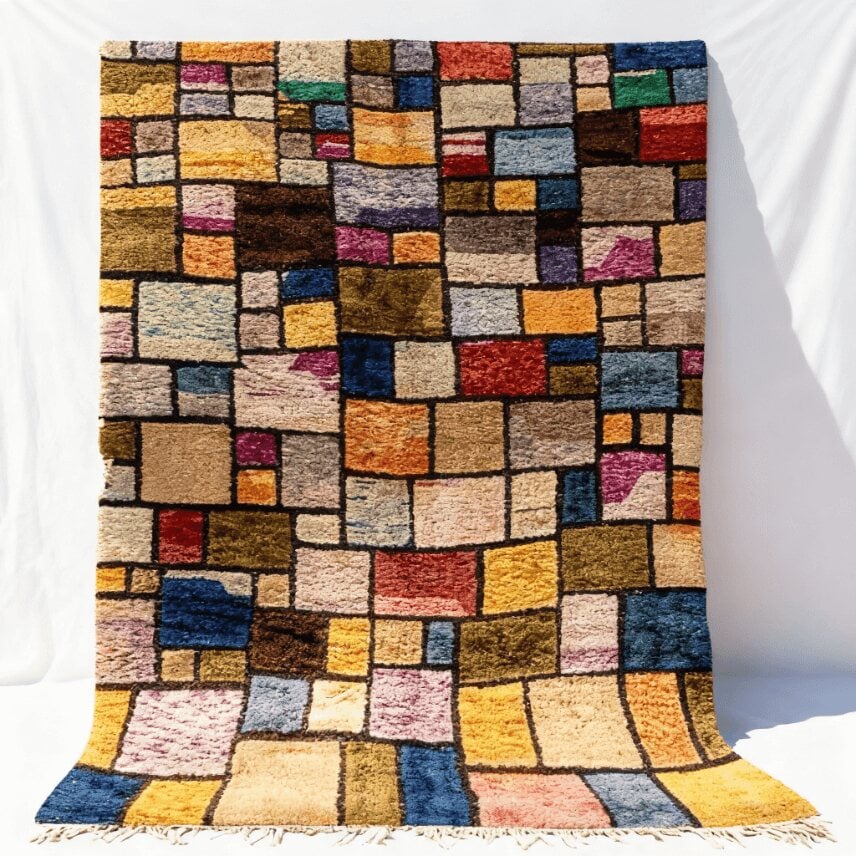 Handwoven Mrirt wool patchwork color block rug with vibrant jewel-tone geometric squares and black grid lines on white background