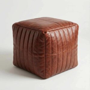 Light brown channel stitched leather cube ottoman pouf on white studio background