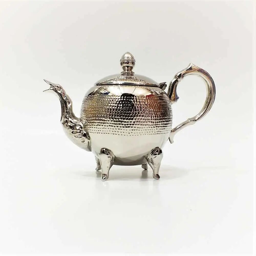 Dragon spout hammered silver teapot with hand-hammered texture, round bulbous body, and four ornate claw feet on white b Dragon spout hammered silver teapot with hand-hammered texture, round bulbous body, and four ornate claw feet on white background