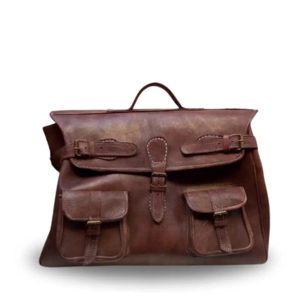 Brown leather messenger bag with fold-over flap, brass buckle straps, and two front flap pockets