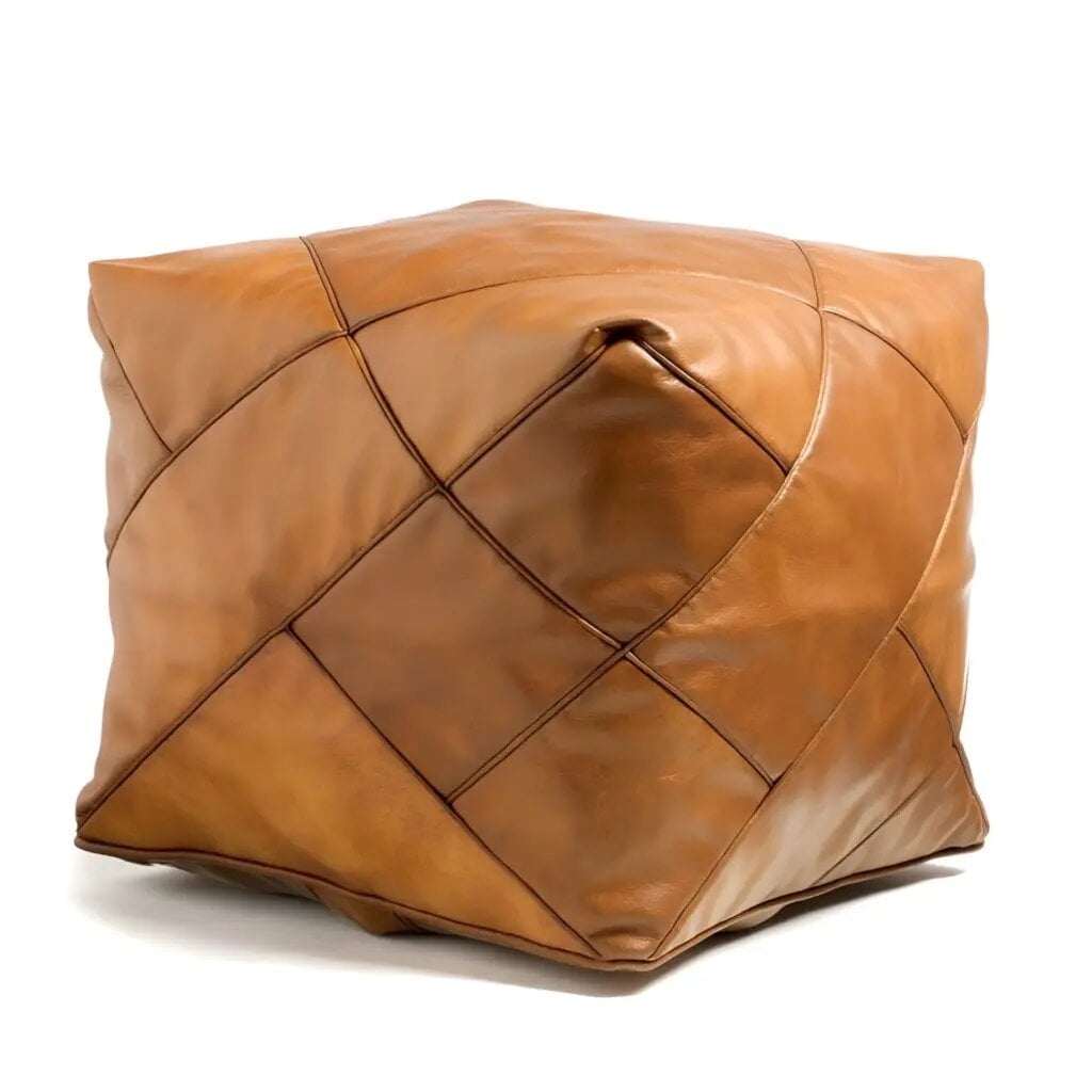 Square leather floor pouf with geometric diamond stitching in tan brown, studio product shot Square leather floor pouf with geometric diamond stitching in tan brown, studio product shot