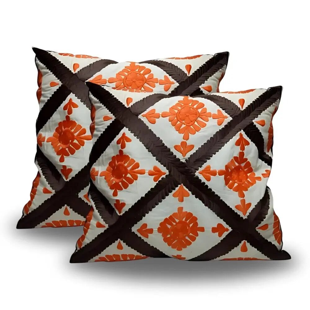 Berber diamond pillow covers set with terracotta floral appliqué and brown lattice pattern on cream background Berber diamond pillow covers set with terracotta floral appliqué and brown lattice pattern on cream background