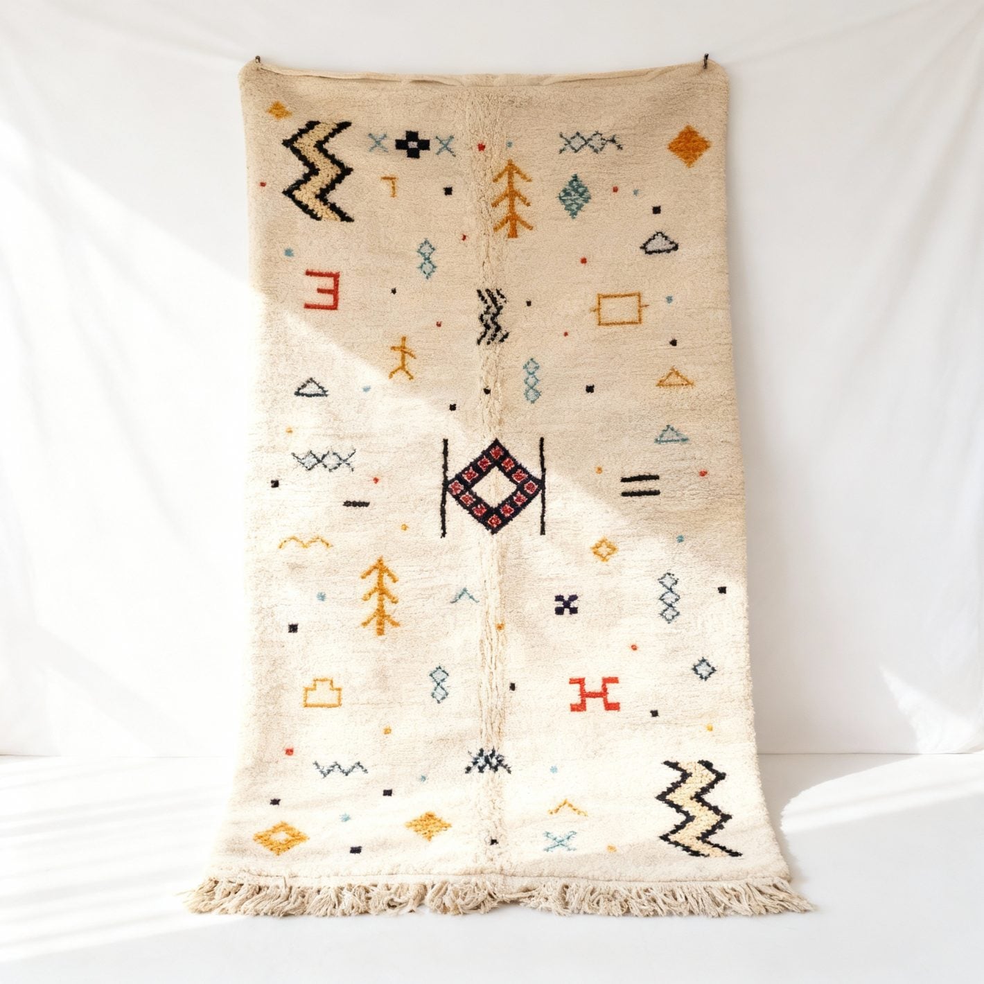 Multicolor Moroccan boho wool rug with geometric Berber patterns on cream ground, handknotted Azilal design