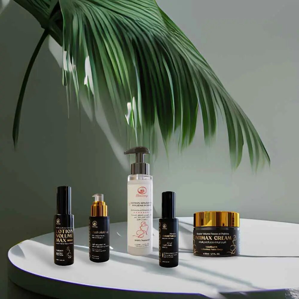 Natural butt enhancement premium 5-product set with firming cream, lotions, and oils on white tray with palm leaf