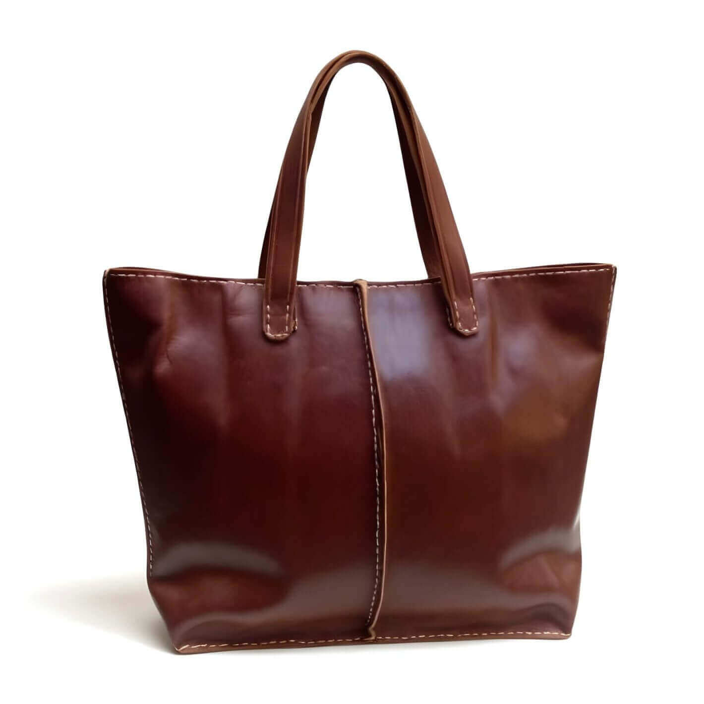Cognac leather market tote bag with contrast stitching and open top, displayed on white background