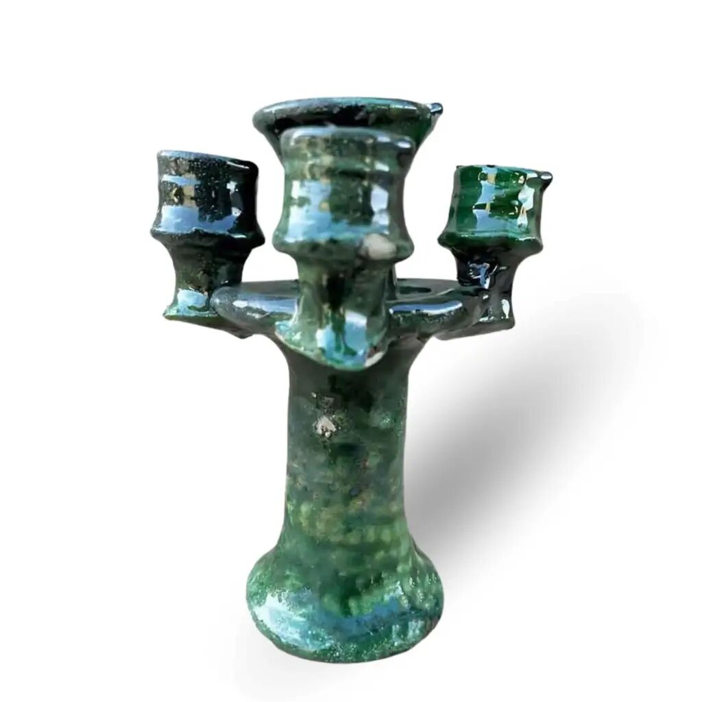 Green Tamegroute ceramic candlestick holder with triple arms and glossy glaze finish on white background Green Tamegroute ceramic candlestick holder with triple arms and glossy glaze finish on white background
