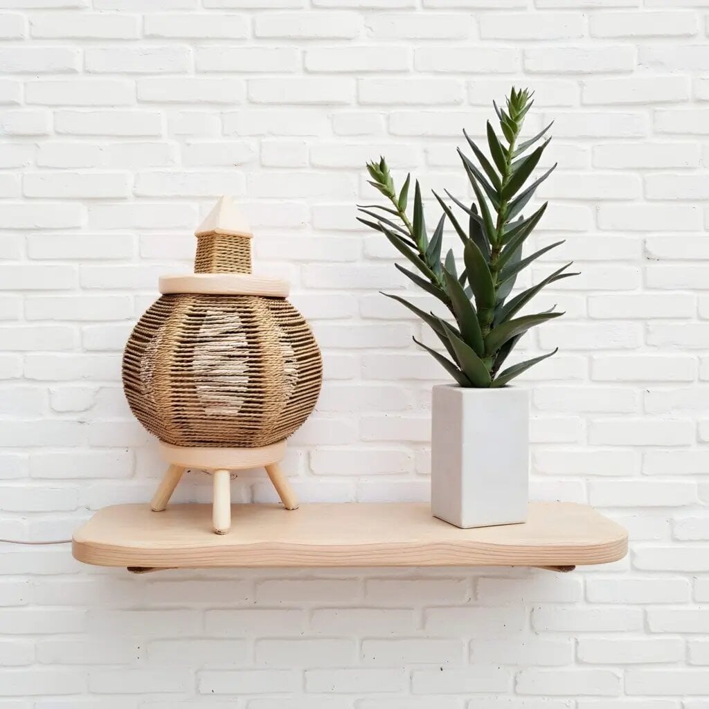 Round lemon wood lighting 9" with handwoven straw shade on natural wood shelf beside white planter and succulent