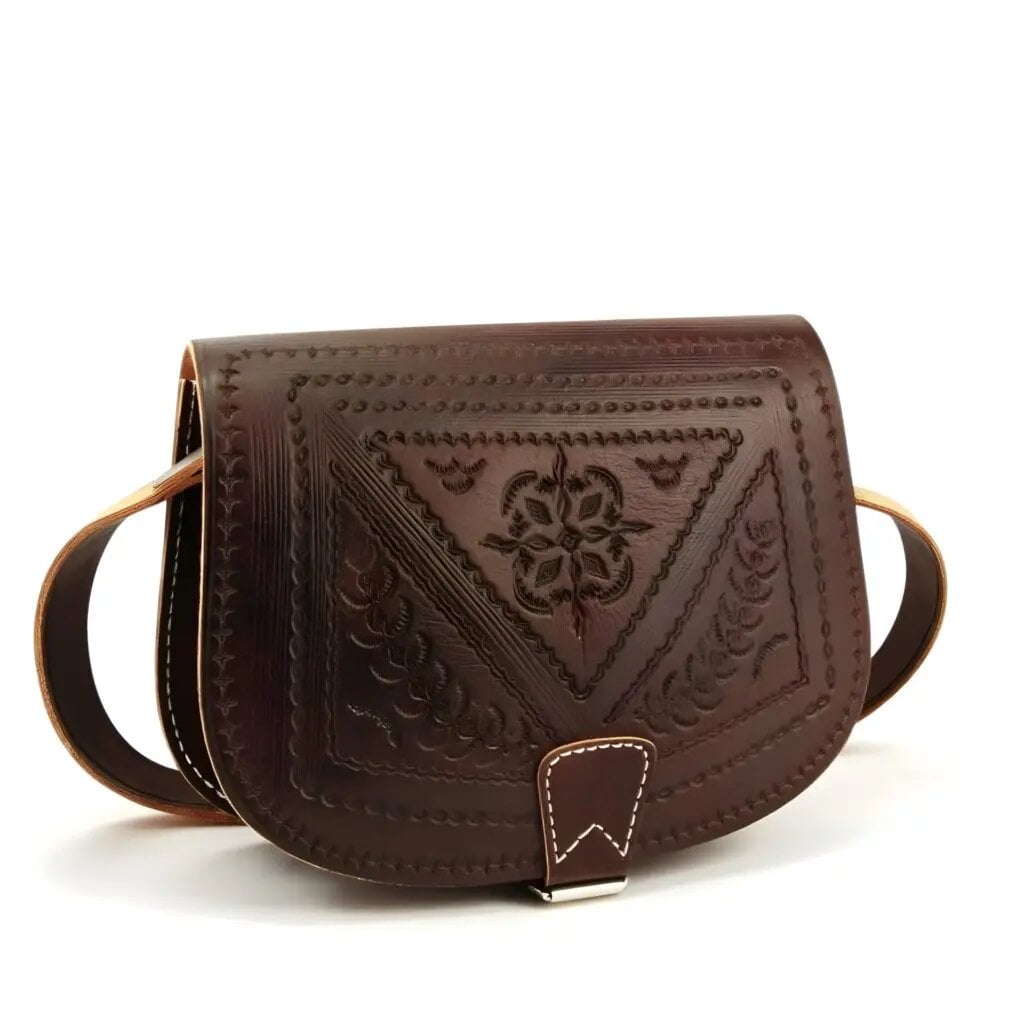 Brown hand-tooled embossed leather saddle bag with floral medallion and geometric border pattern