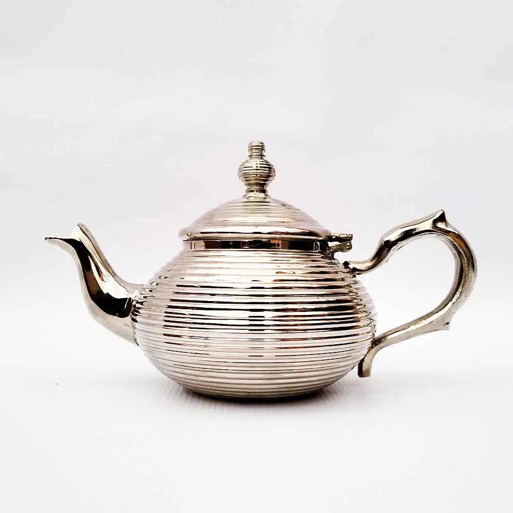 Ribbed globe Moroccan teapot in silver-plated brass with horizontal coil pattern, photographed on a white background.