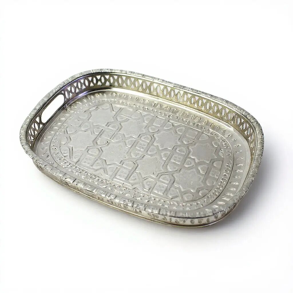 Rectangular silver-plated brass geometric serving tray with hand-embossed arabesque surface and pierced lattice rim Rectangular silver-plated brass geometric serving tray with hand-embossed arabesque surface and pierced lattice rim