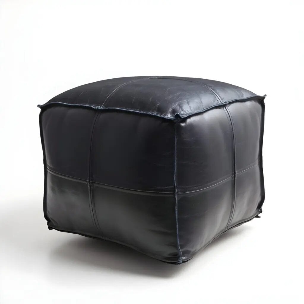 Handcrafted black leather square pouf ottoman with clean geometric lines on white studio background Handcrafted black leather square pouf ottoman with clean geometric lines on white studio background