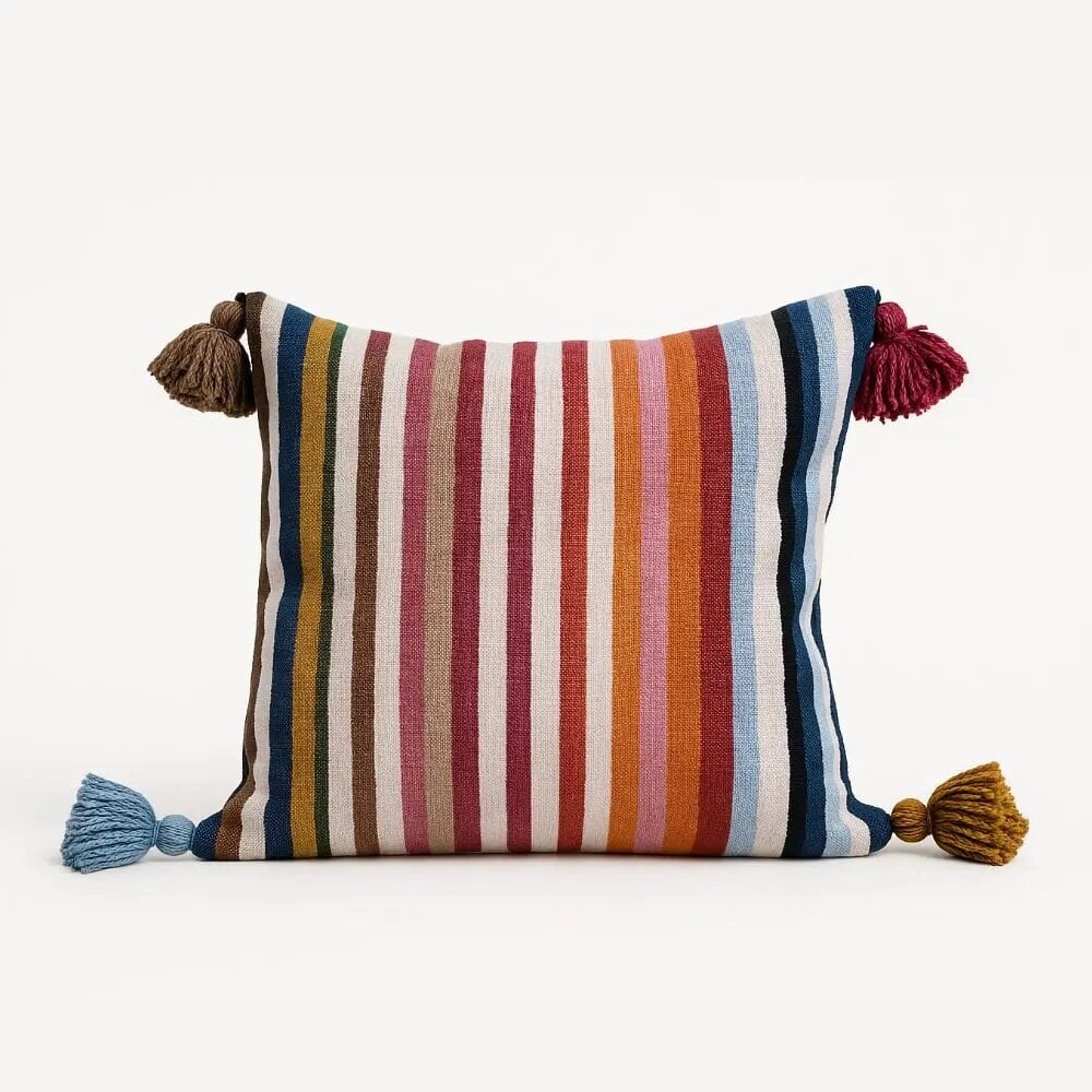 Vibrant striped cushion covers with multicolor vertical stripes and decorative tassels on all four corners