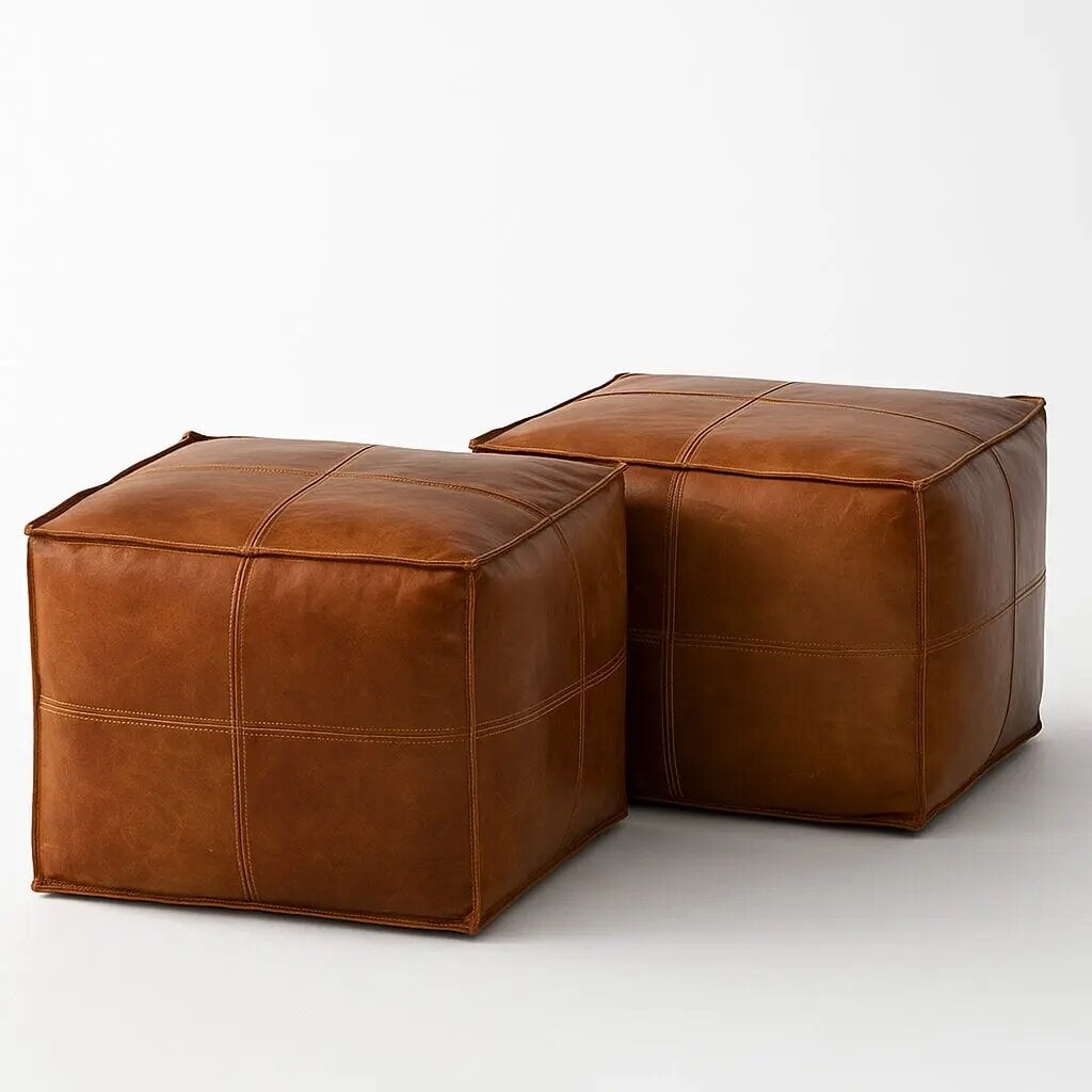 Handcrafted square leather ottoman set of 2 in light brown with contrast topstitching on white background Handcrafted square leather ottoman set of 2 in light brown with contrast topstitching on white background