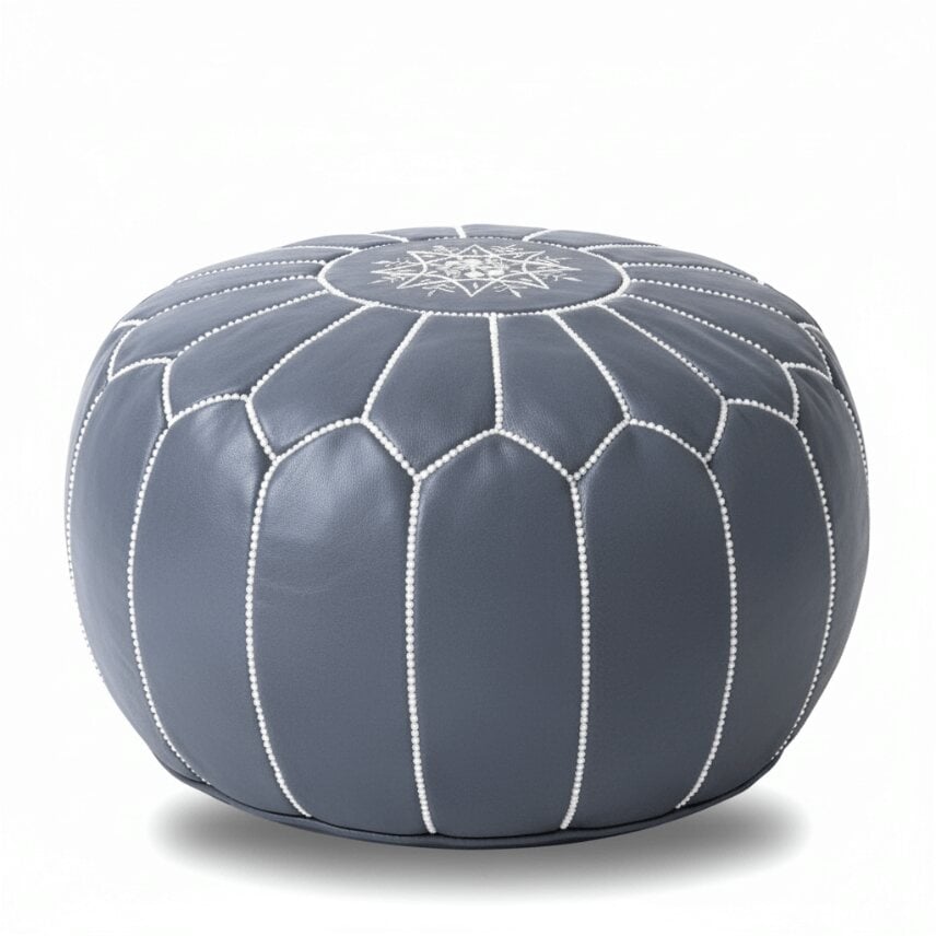 Gray leather round ottoman with white geometric stitching, handcrafted Moroccan pouf on white background Gray leather round ottoman with white geometric stitching, handcrafted Moroccan pouf on white background