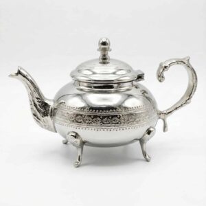 Diamond pattern silver teapot with domed lid, curved spout, and C-shaped handle on white background Diamond pattern silver teapot with domed lid, curved spout, and C-shaped handle on white background