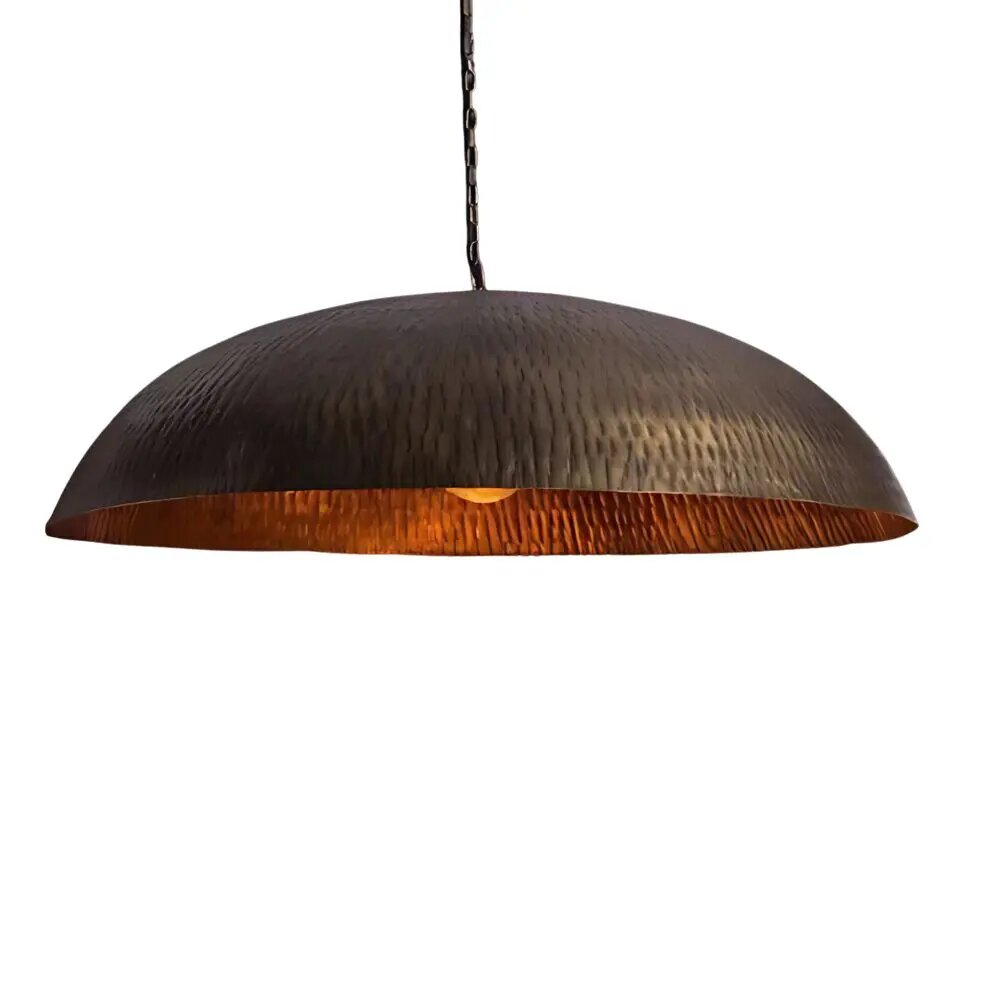 Hammered brass pendant light with oxidized dome exterior and warm copper interior, hand-forged textured finish