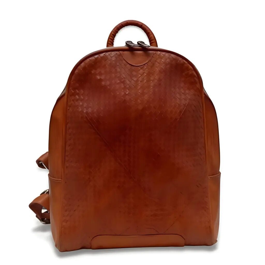 Handcrafted small woven leather backpack in cognac brown featuring a basket-weave pattern and wrapped top handle Handcrafted small woven leather backpack in cognac brown featuring a basket-weave pattern and wrapped top handle