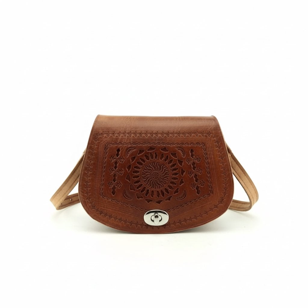 Embossed leather mandala crossbody bag in cognac brown with hand-tooled geometric pattern and turn-lock clasp