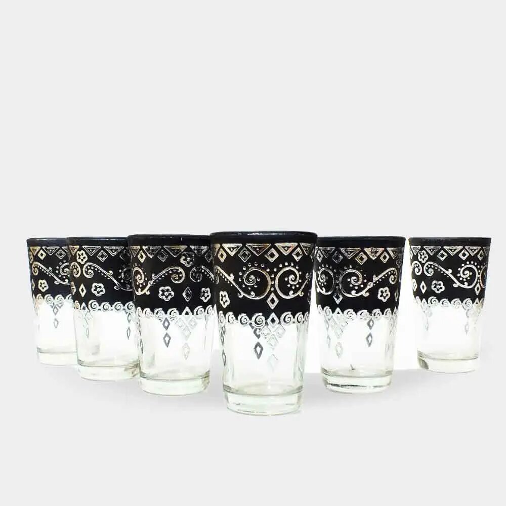 Set of six black Moroccan tea glasses featuring hand-painted silver enamel arabesque scrollwork on white background Set of six black Moroccan tea glasses featuring hand-painted silver enamel arabesque scrollwork on white background