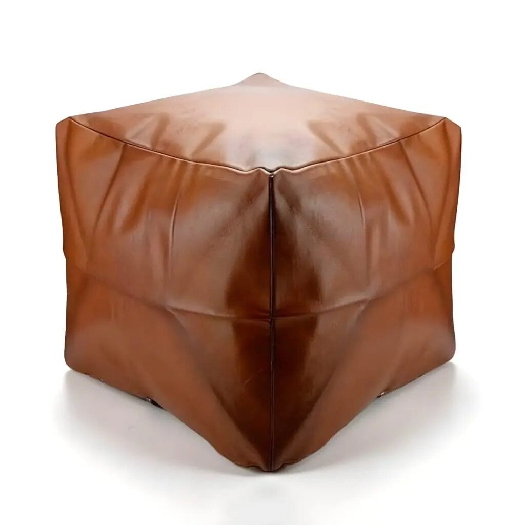 Light brown square leather ottoman on white background, handmade minimalist pouf with cushioned top and clean seams