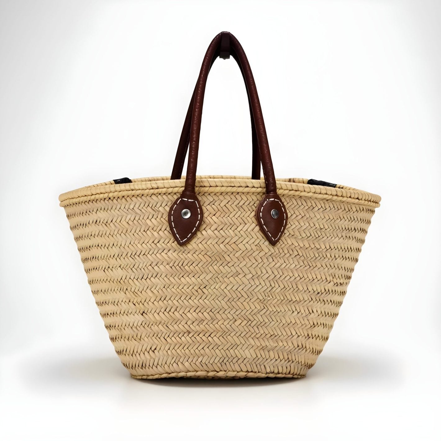 straw bag with herringbone palm leaf weave and dark brown leather handles